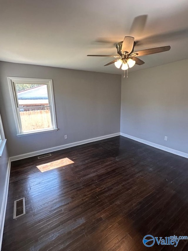 empty room featuring ceiling fan and dark hardwood / wood-style floors