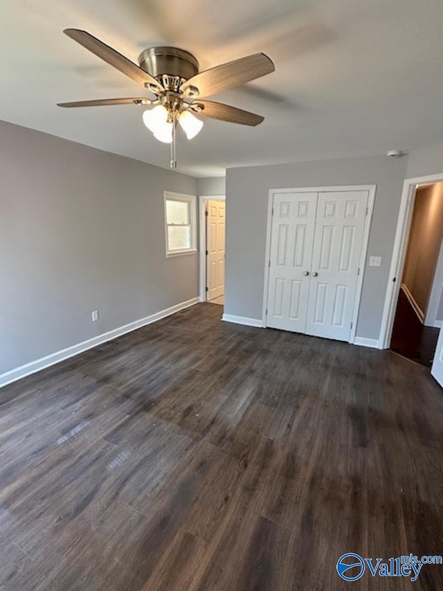 unfurnished bedroom with ceiling fan, a closet, and dark hardwood / wood-style flooring