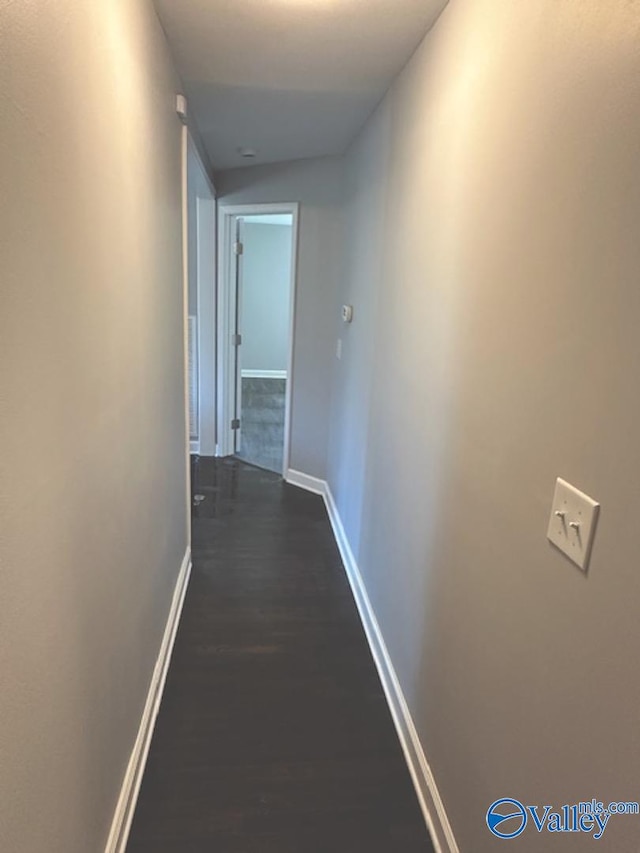 hallway with dark wood-type flooring