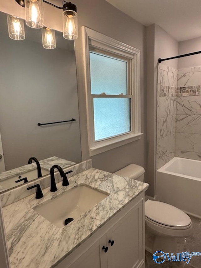 full bathroom featuring vanity, tiled shower / bath combo, toilet, and tile patterned floors