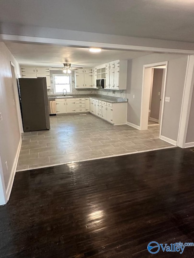 kitchen with ceiling fan, sink, light hardwood / wood-style flooring, white cabinetry, and appliances with stainless steel finishes