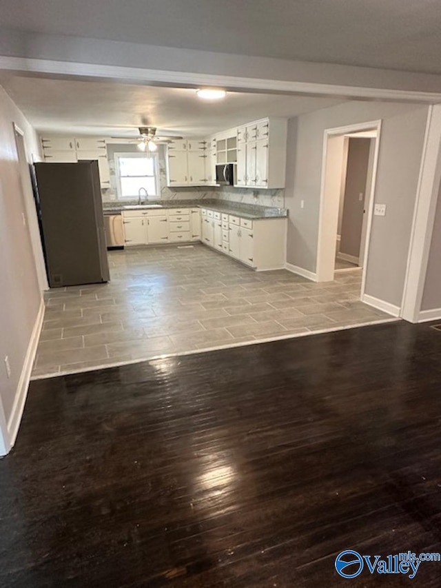 kitchen featuring white cabinets, sink, tasteful backsplash, light hardwood / wood-style flooring, and stainless steel appliances