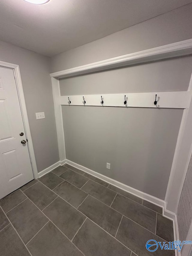 mudroom featuring dark tile patterned floors