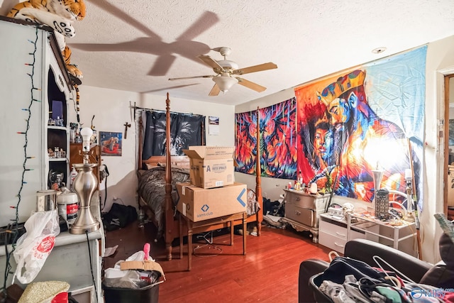 interior space featuring ceiling fan, hardwood / wood-style floors, and a textured ceiling