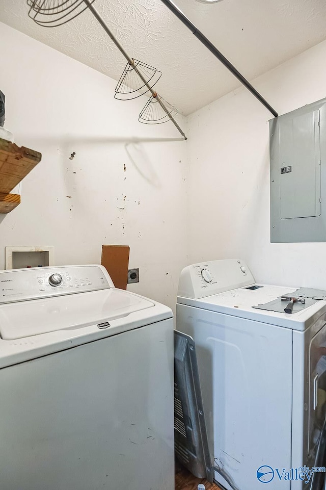 laundry room featuring washing machine and clothes dryer and electric panel