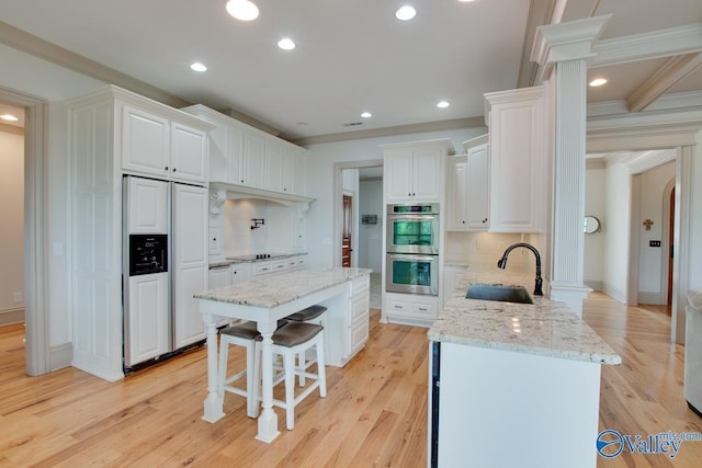 2602 Legacy Preserve Dr, Brownsboro, AL 35741 - kitchen featuring paneled refrigerator, stainless steel double oven, a sink, white cabinetry, and crown molding