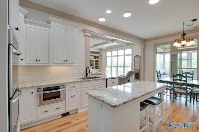 2602 Legacy Preserve Dr, Brownsboro, AL 35741 - kitchen with a sink, a chandelier, dishwashing machine, light wood finished floors, and coffered ceiling