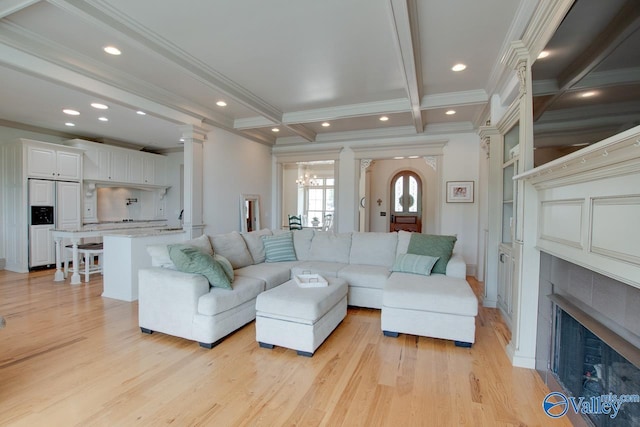 2602 Legacy Preserve Dr, Brownsboro, AL 35741 - living area featuring crown molding, light wood-type flooring, a tile fireplace, beam ceiling, and a chandelier