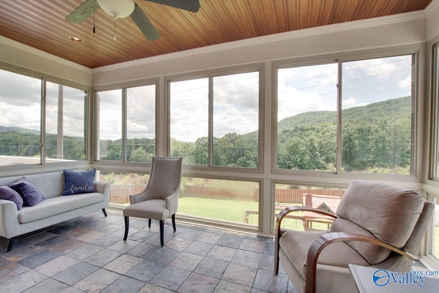 2602 Legacy Preserve Dr, Brownsboro, AL 35741 - sunroom / solarium with ornamental molding, a mountain view, a ceiling fan, stone tile flooring, and wooden ceiling
