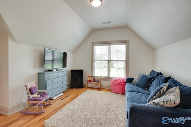 2602 Legacy Preserve Dr, Brownsboro, AL 35741 - living area featuring light wood-style flooring and vaulted ceiling