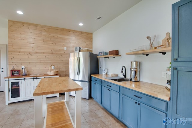 2602 Legacy Preserve Dr, Brownsboro, AL 35741 - kitchen featuring butcher block counters, freestanding refrigerator, a sink, open shelves, and blue cabinets