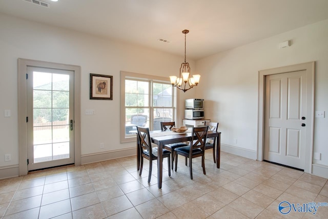 2602 Legacy Preserve Dr, Brownsboro, AL 35741 - dining area with a chandelier, plenty of natural light, and light tile patterned floors