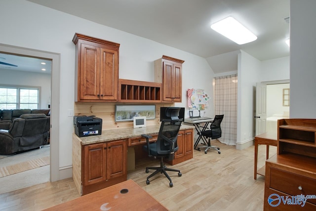 2602 Legacy Preserve Dr, Brownsboro, AL 35741 - home office with vaulted ceiling, light wood-style floors, built in desk, and baseboards
