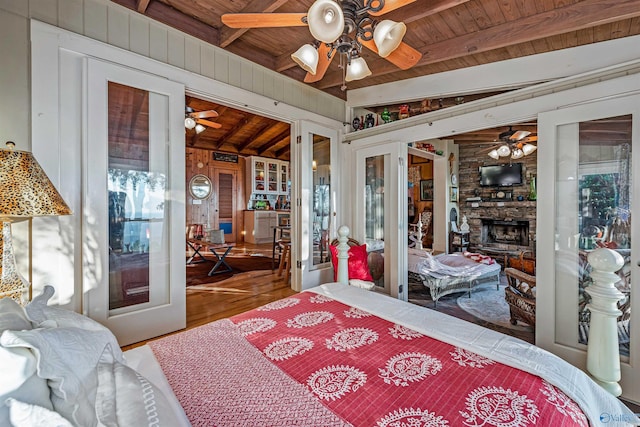 bedroom with french doors, wood-type flooring, beam ceiling, and wooden ceiling