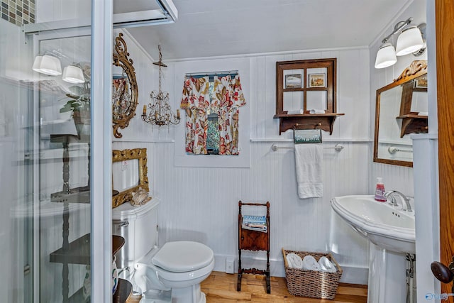 bathroom with walk in shower, sink, hardwood / wood-style floors, and toilet