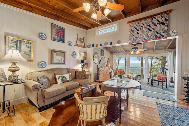 living room with beam ceiling, wood ceiling, and plenty of natural light