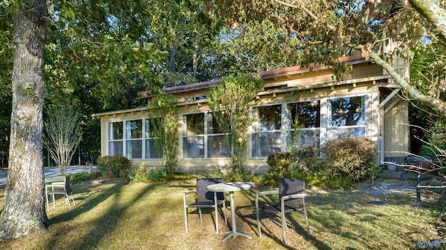 rear view of property featuring a yard