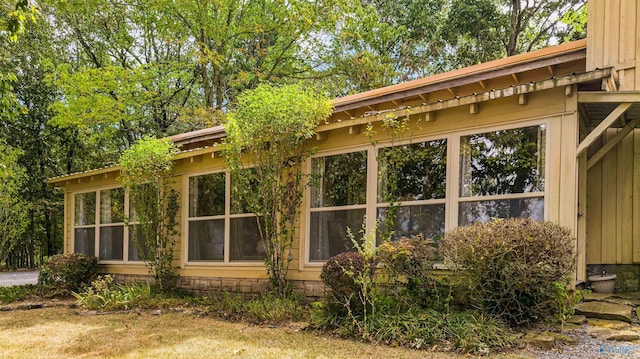 view of side of property featuring a sunroom