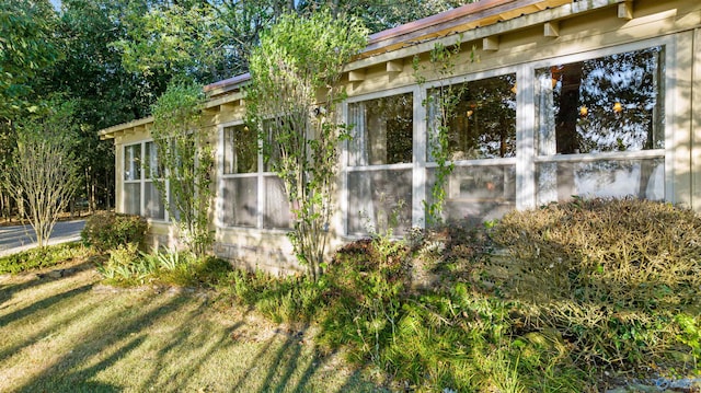 view of side of home featuring a lawn