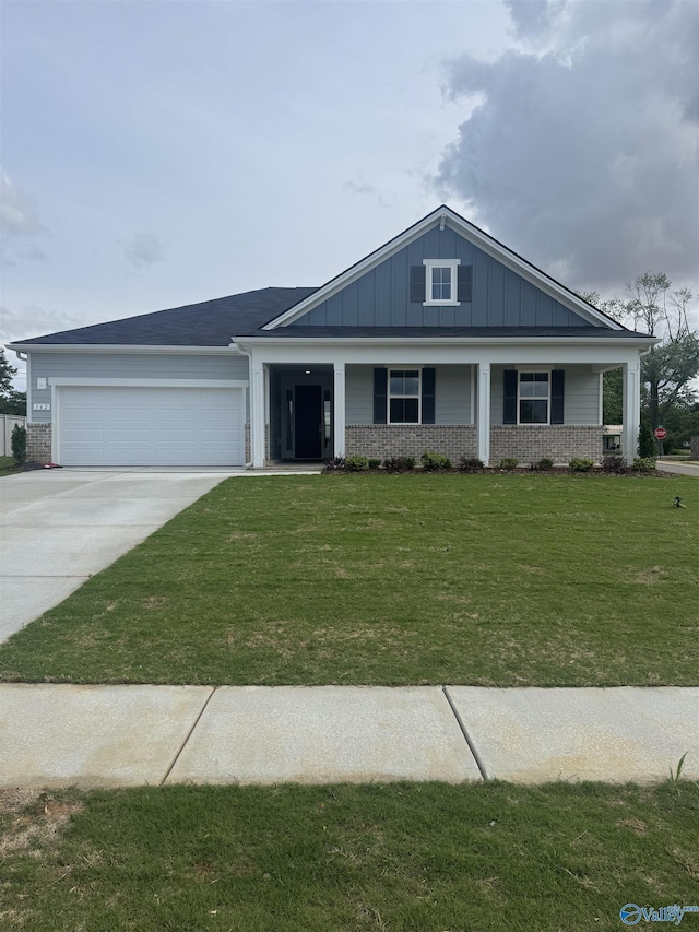 view of front facade featuring an attached garage, brick siding, driveway, and board and batten siding