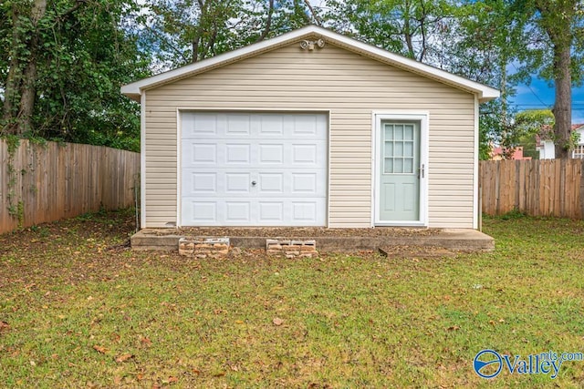 garage featuring a yard and wooden walls