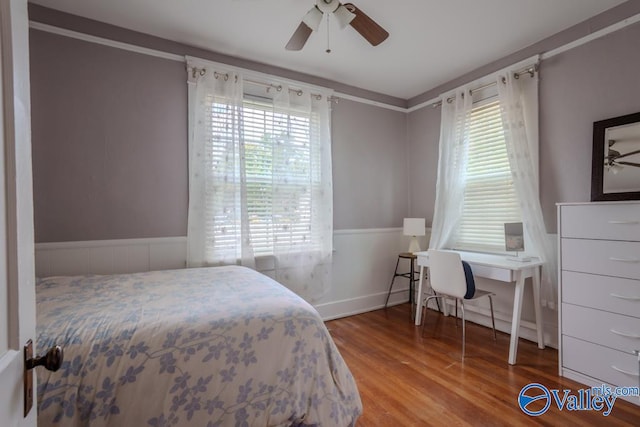 bedroom with ceiling fan and hardwood / wood-style flooring