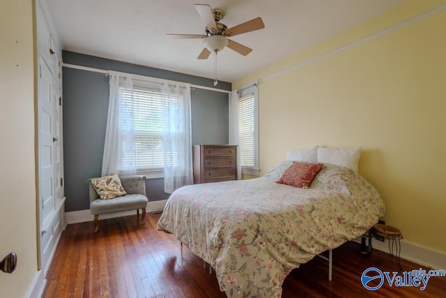 bedroom featuring ceiling fan and dark hardwood / wood-style flooring