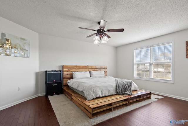 bedroom featuring baseboards, a textured ceiling, and hardwood / wood-style flooring