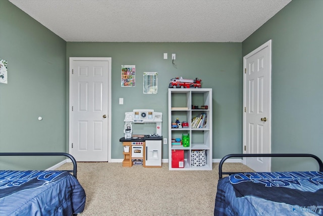 bedroom featuring baseboards, carpet floors, and a textured ceiling