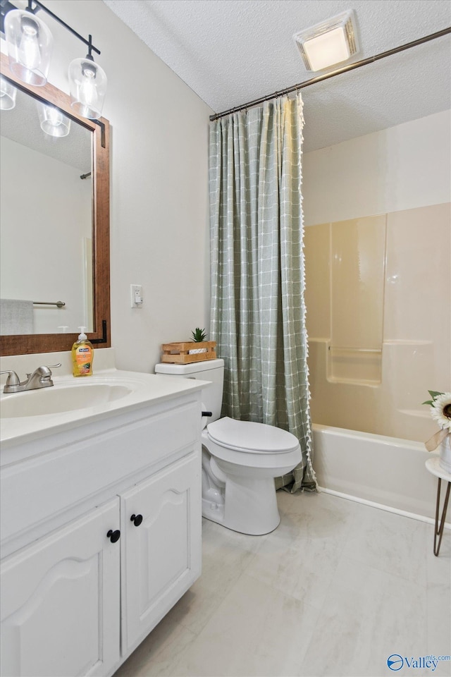 bathroom with toilet, vanity, a textured ceiling, and visible vents