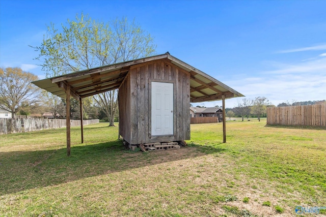 view of outdoor structure with an outbuilding and fence