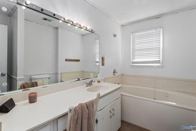 full bath featuring visible vents, vanity, and a garden tub