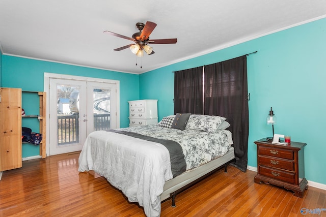 bedroom featuring access to exterior, wood finished floors, french doors, baseboards, and ceiling fan