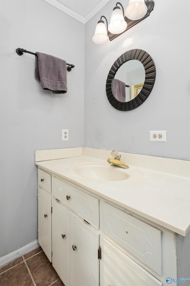 bathroom with baseboards, ornamental molding, vanity, and tile patterned flooring