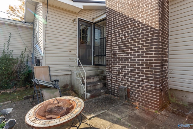 view of exterior entry featuring brick siding