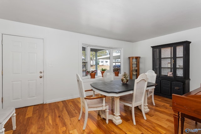 dining room with light wood-style floors and baseboards