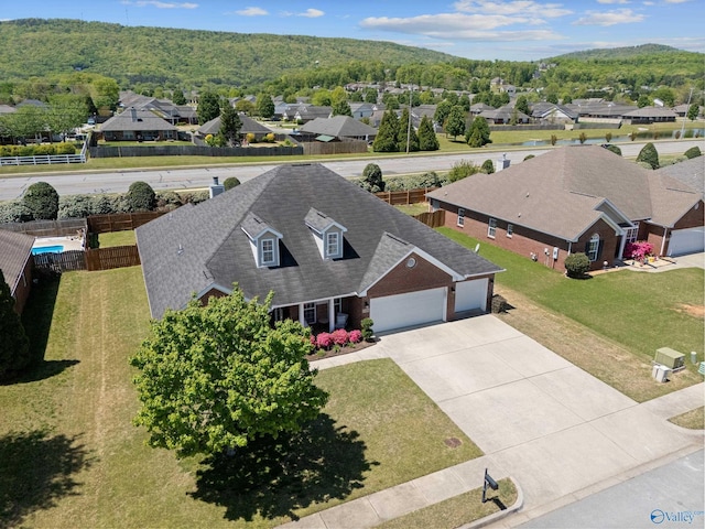 birds eye view of property with a residential view and a view of trees