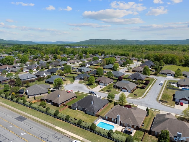 aerial view featuring a mountain view, a residential view, and a wooded view
