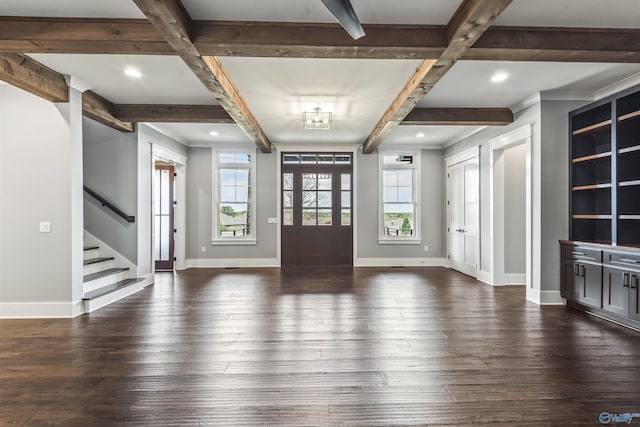 entrance foyer featuring dark wood-type flooring, beamed ceiling, stairway, and baseboards