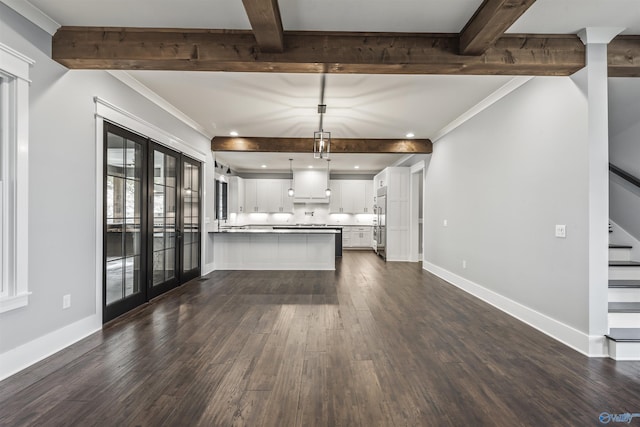 kitchen with dark wood-style flooring, beam ceiling, hanging light fixtures, open floor plan, and white cabinets