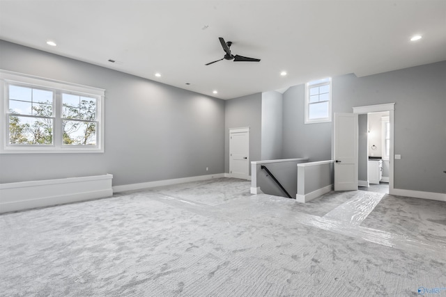 unfurnished room with light carpet, ceiling fan, baseboards, and recessed lighting