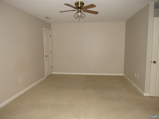 carpeted spare room with ceiling fan