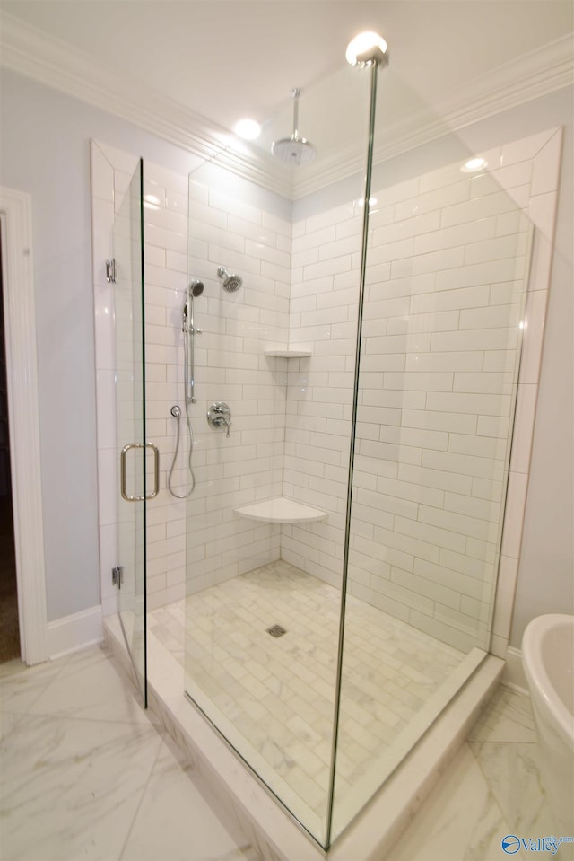 bathroom with ornamental molding and a shower with door