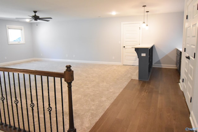 interior space with ceiling fan and dark wood-type flooring