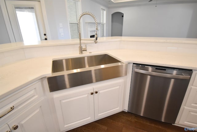 kitchen with dark hardwood / wood-style flooring, white cabinetry, sink, and stainless steel dishwasher