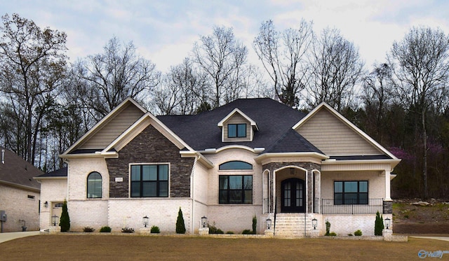 view of front of property with a porch and a front lawn