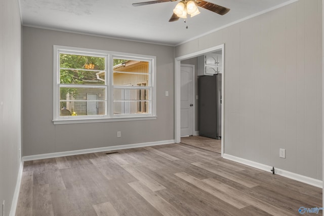 2703 Oakdale Ter, Huntsville, AL 35810 - spare room featuring a ceiling fan, wood finished floors, and ornamental molding