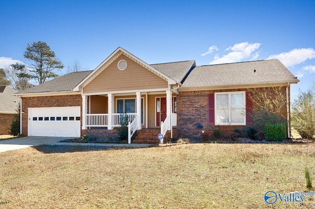 view of front of house featuring driveway, covered porch, a front yard, a garage, and brick siding