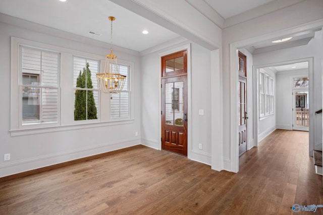 27 Lendon Main St, Huntsville, AL 35802 - entryway featuring baseboards, an inviting chandelier, crown molding, visible vents, and wood finished floors