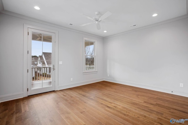 empty room featuring crown molding, light hardwood / wood-style flooring, and ceiling fan